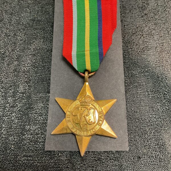 WWII Pacific Star medal with ribbon, a vintage military collectible.