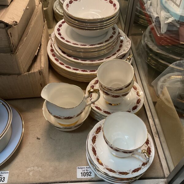 Stack of vintage Paragon Elegance dinner plates with burgundy floral pattern.