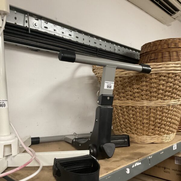 Side view of a silver pedal exerciser for home fitness.