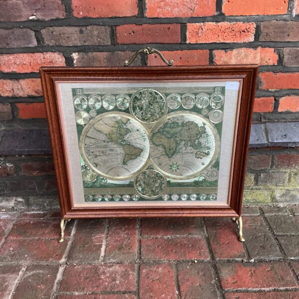 Antique Peter Schenk world map fire guard in oak frame.