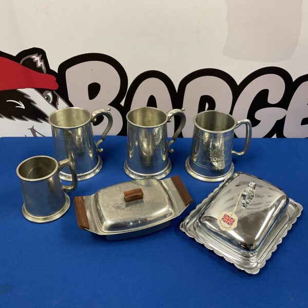 Vintage pewter tankards with silver skull details and a cheese cloche.