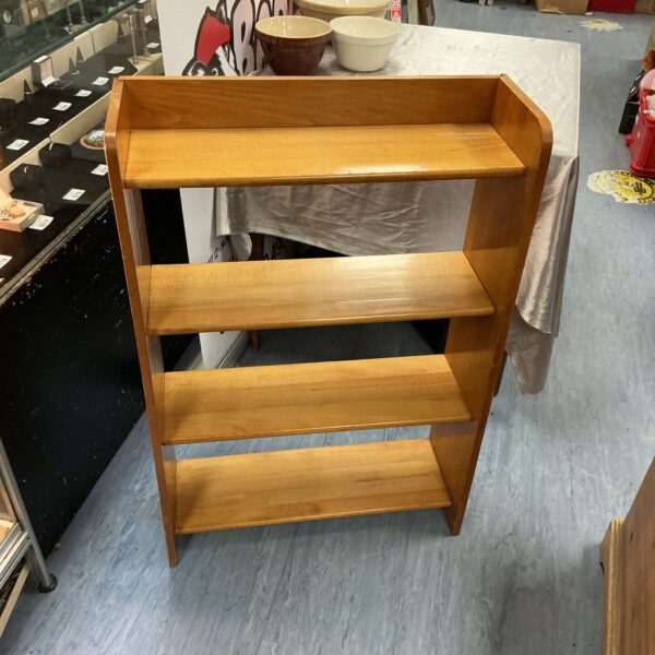 Front view of a rustic pine bookcase with three shelves.