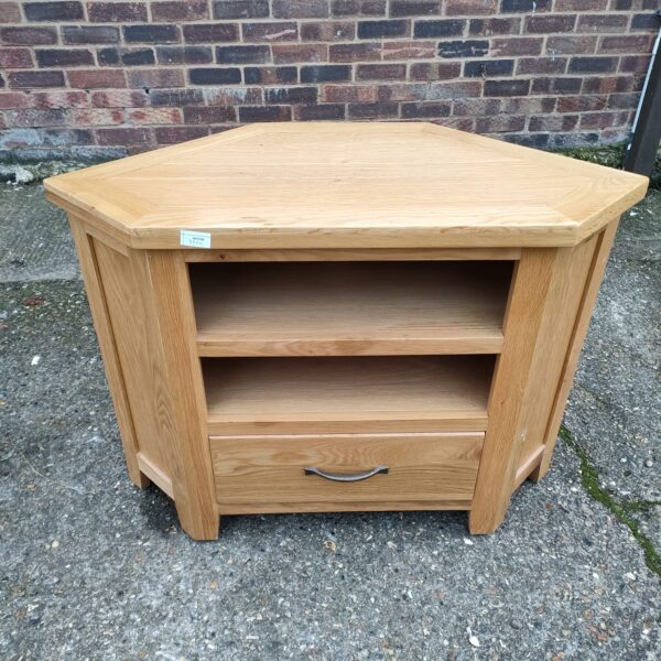 Vintage pine corner media cabinet with drawer and shelves.