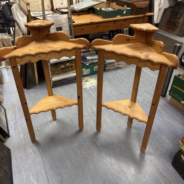 Vintage pine corner units with wave edge detailing for display.