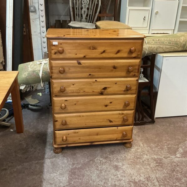 Vintage pine six-drawer cabinet with rustic charm.