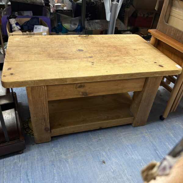 Rustic pitched pine coffee table with visible grain and character.