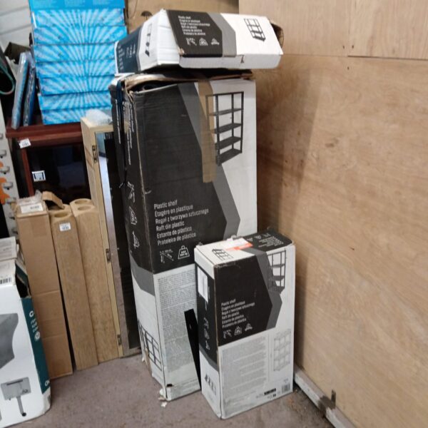 Stack of used plastic shelving units for home storage.
