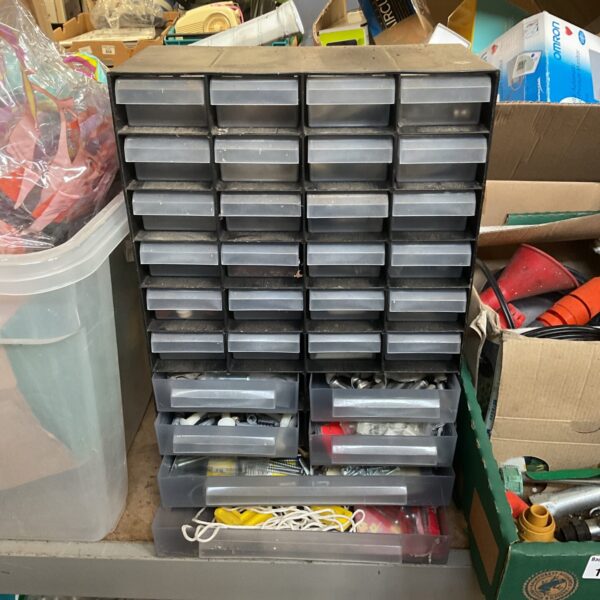 Multi-drawer plastic storage unit filled with screws and bolts.