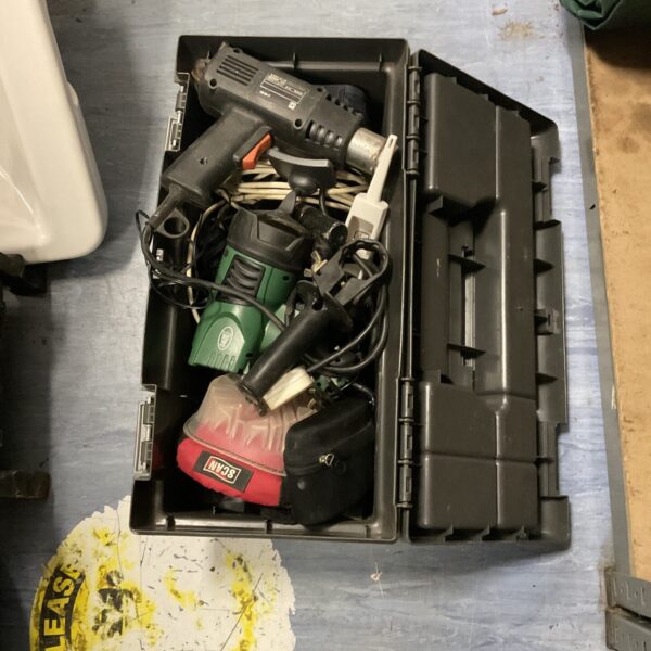 Plastic toolbox filled with various hand tools and a heat gun.