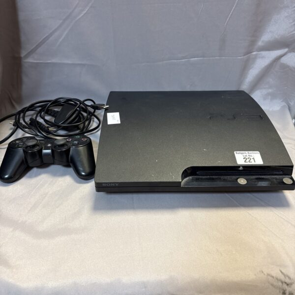 Black Sony PlayStation 3 Slim gaming console with controller.