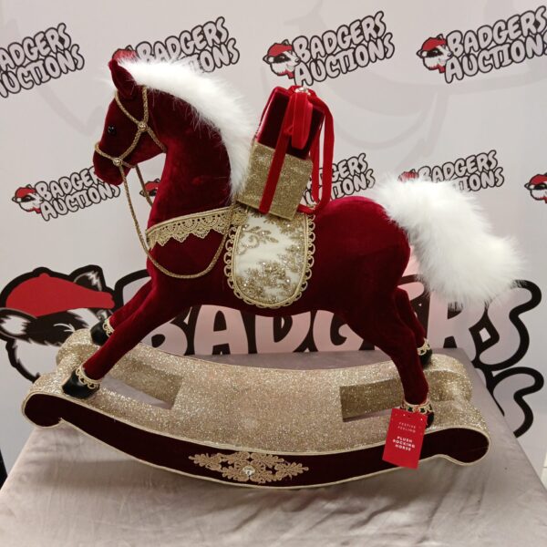 Red plush rocking horse decoration for festive holiday displays.