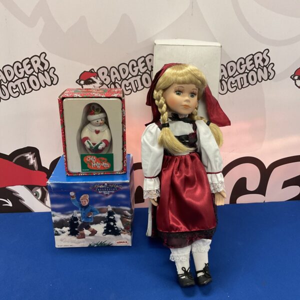 Detailed porcelain Christmas doll, festive holiday ornament.