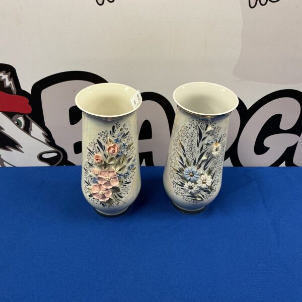 Two porcelain vases with vibrant floral designs for home decor.