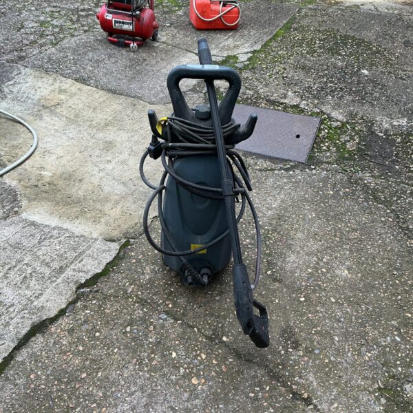 Portable power washer with hose and wheels for outdoor cleaning.