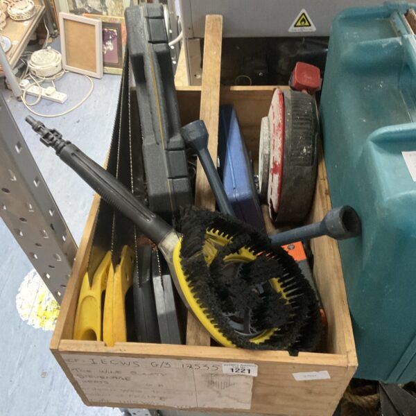 A box of assorted pressure washer attachments and garden tools.