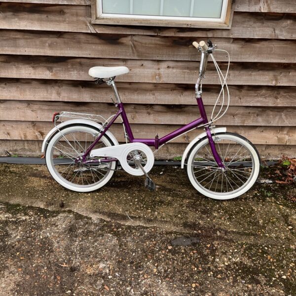 Vintage purple Raleigh folding bike for commuters and collectors.