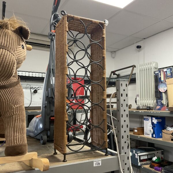 Vintage rattan wine bottle rack for home display.