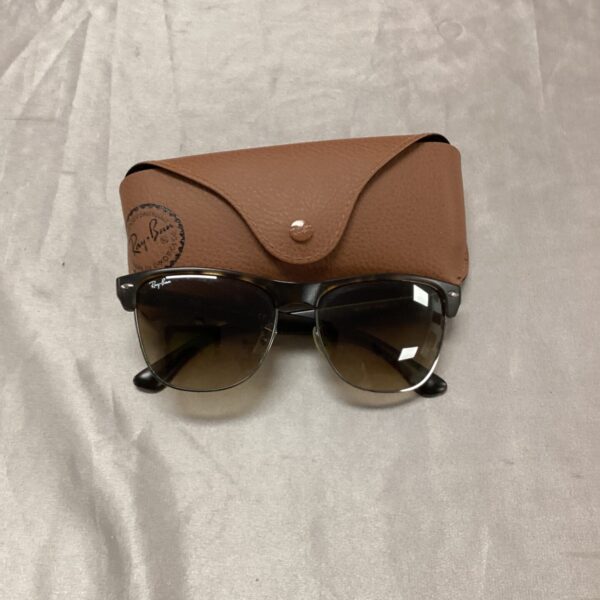 Vintage Ray-Ban sunglasses with dark lenses and sleek frame.