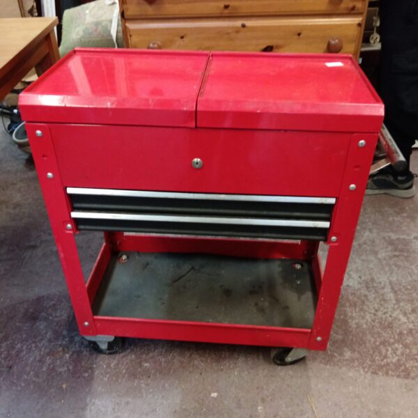 Red metal engineers cabinet with three drawers on wheels.