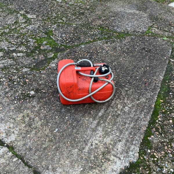 Red portable petrol tank for motor boat use.