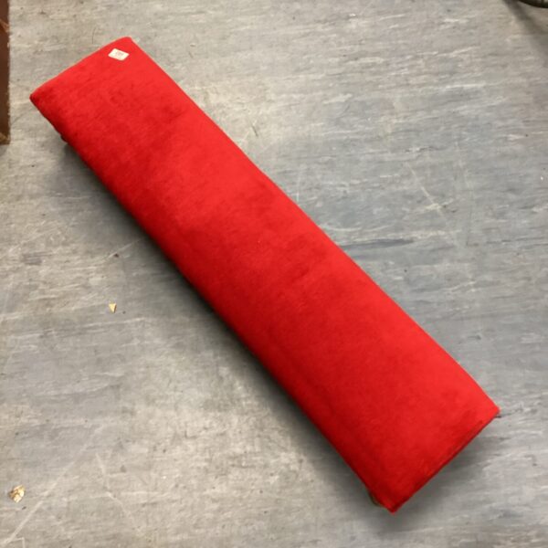 Red kneeling prayer stool for meditation and religious practice.