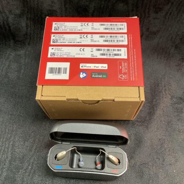 Resound hearing aids inside open charging box.