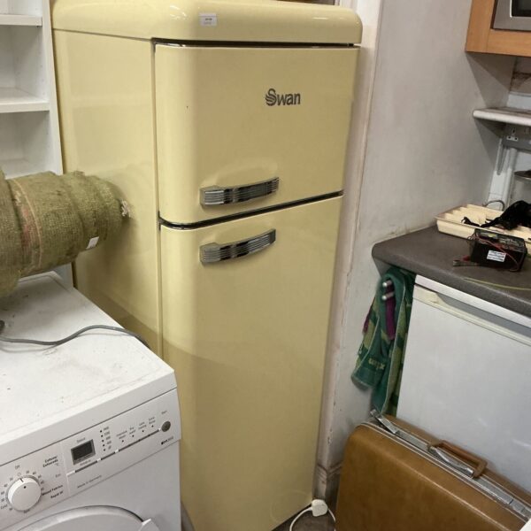 Yellow retro Swan fridge freezer in a vintage kitchen setting.