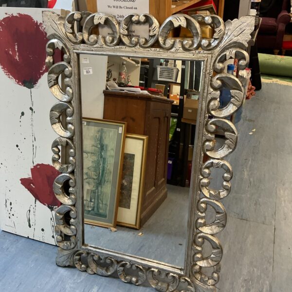 Ornate silver toned Rococo style mirror with detailed frame.