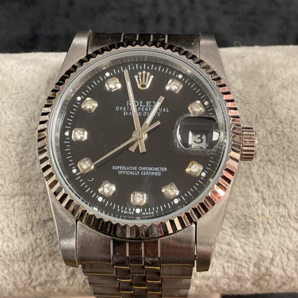Vintage Rolex Oyster automatic wristwatch with black dial.
