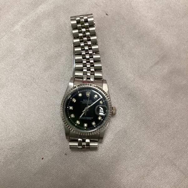 Vintage Rolex Oyster automatic wristwatch with black dial.