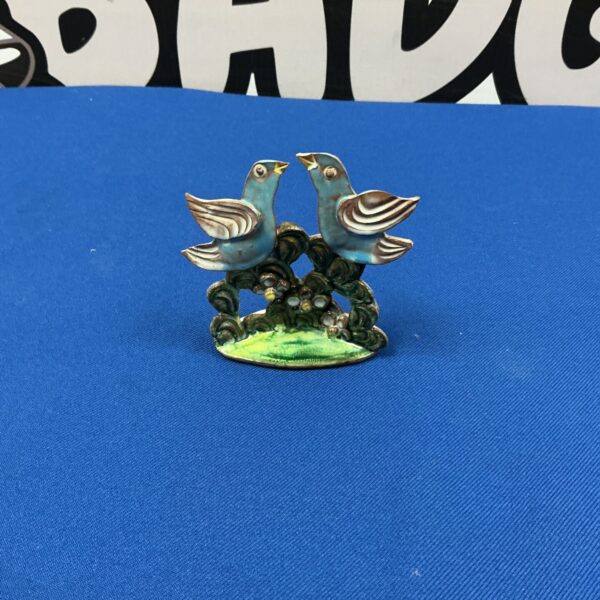 Vintage Romola Jane ceramic bird figurines on a branch.