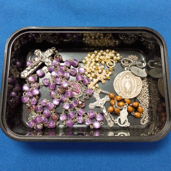 Vintage purple rosary beads with a crucifix and medallion.