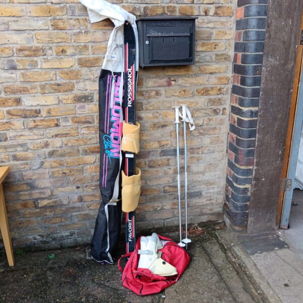 Vintage Rossignol skis and Nordica boots set for winter sports.