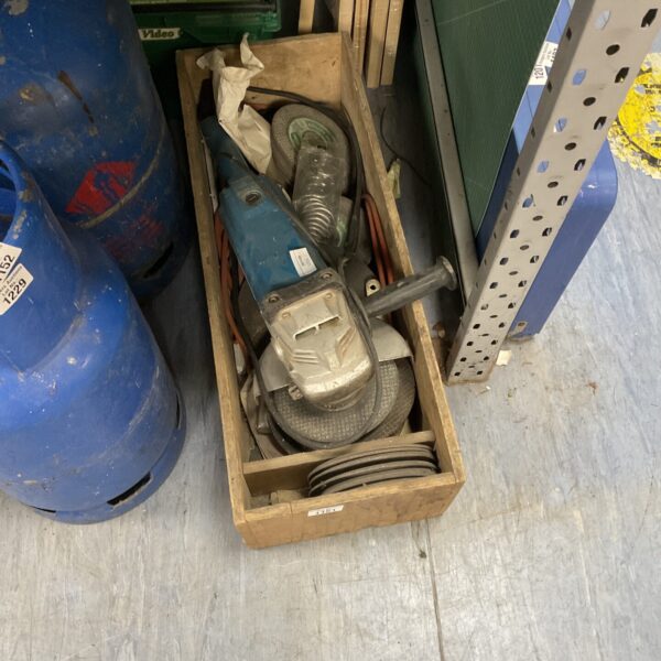 Ryobi disc cutter with spare cutting discs in a wooden crate.