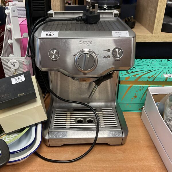 Sleek Sage Nespresso coffee machine on a countertop.