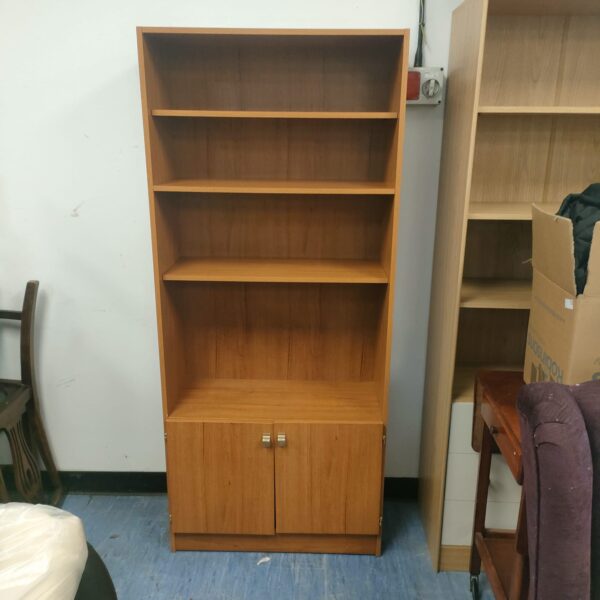 Front view of a vintage Schreiber wooden bookcase with open shelving.