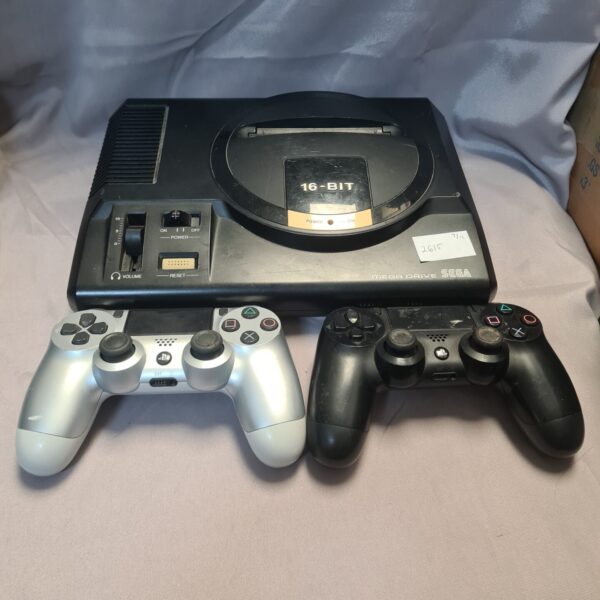 Sega Megadrive 16-bit console with two Dualshock 4 controllers for retro gaming.