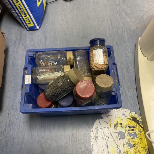 Assorted nails and dowel rods in a shed clearance lot.
