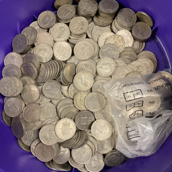 A tub of circulated British shilling coins from George VI and Queen Elizabeth II.