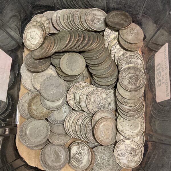 A tub of silver shilling coins, a collectible coin lot.