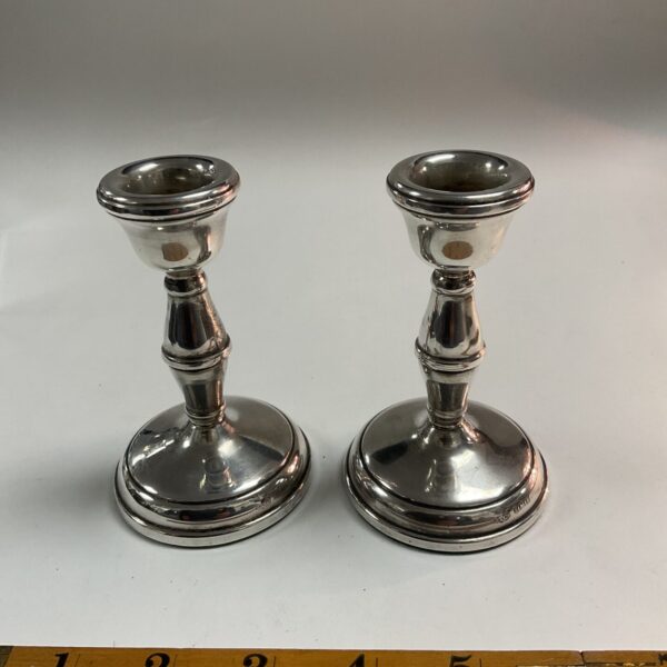 Antique silver candle sticks, a decorative pair for home ambiance.