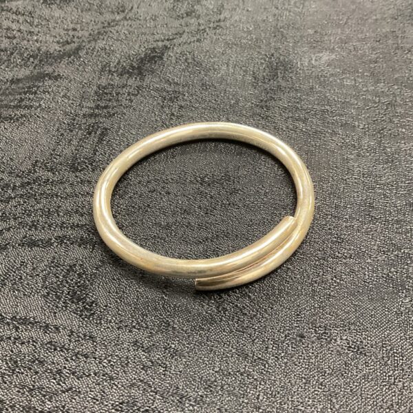 Delicate silver coil bracelet, minimalist jewellery design.