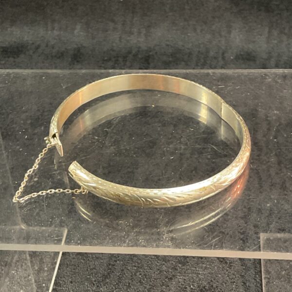 Close-up of a vintage silver hinged bracelet.