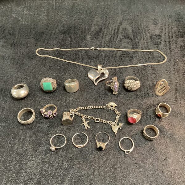 Silver jewellery lot featuring rings, necklace and bracelet.