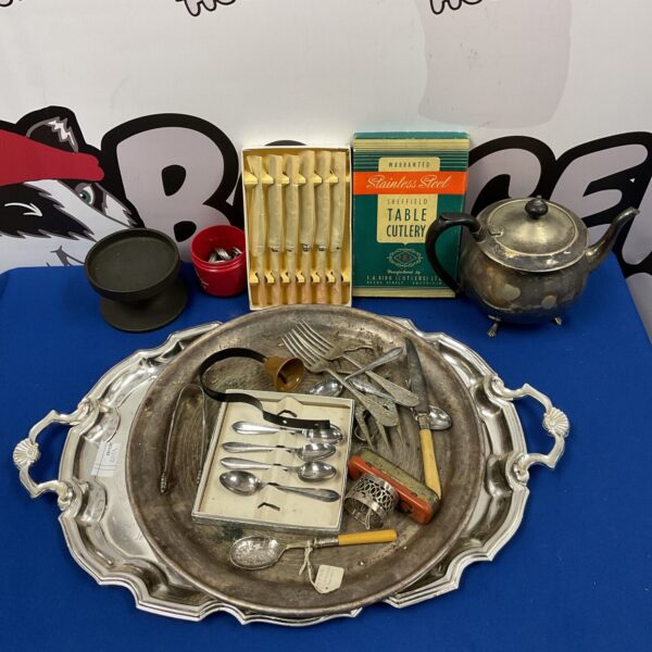 Vintage silver plate tray and cutlery collection on display.