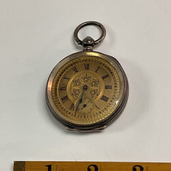 Antique silver pocket watch by Dent & Sons with Roman numeral dial.