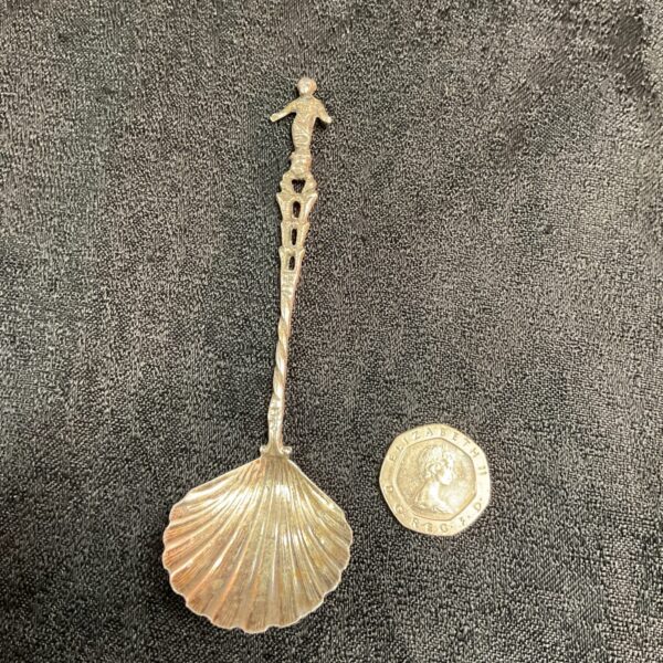 Vintage silver shell preserve spoon with twisted stem.