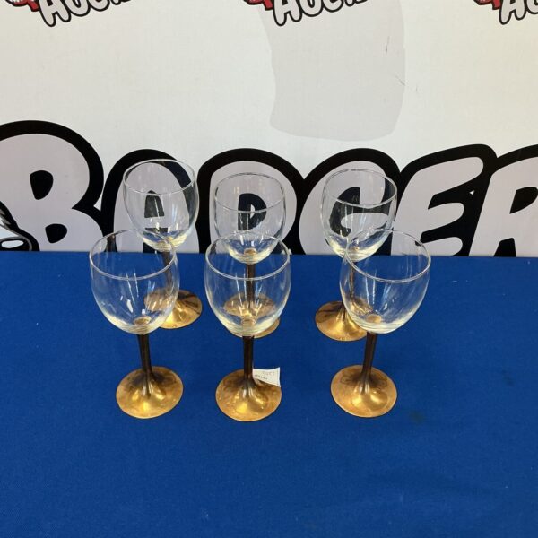 Set of six vintage wine glasses with slender stems.
