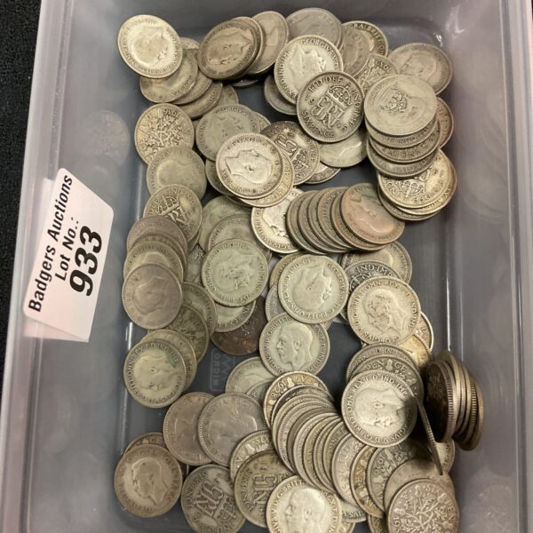 Tub of vintage sixpence coins for collectors.