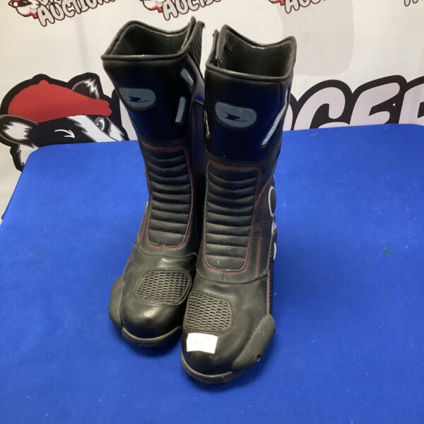 Size 10 motorcycle boots showing wear and tear.